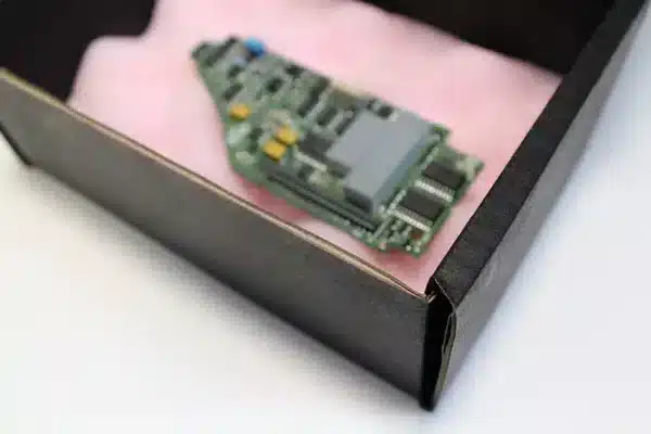 Corstat transit pack with pink anti-static foam and electronic component inside. Bondline Electronics Ltd.