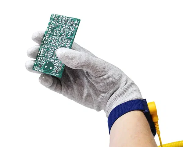 Operator Wearing GT Anti Static Glove With Coated Fingertips Holding A PCB Component and Wearing An ESD Wrist Strap and Cord - Bondline Electronics Ltd